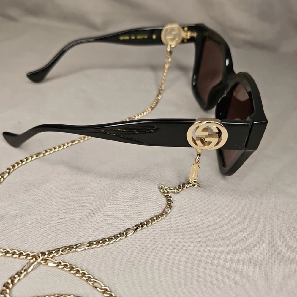Gucci Black Sunglasses with Gold Chain Accent and case. Pre owned not new.